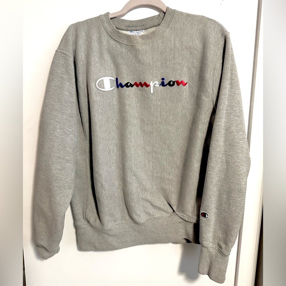 Stitched Red white and blue lettering, champion, crewneck size medium.